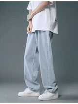 Men’s light blue washed wide leg relaxed fit jeans in extended sizes Small–3XL.