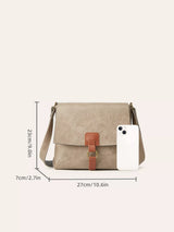 Light gray vintage-style crossbody bag featuring a flap closure, decorative buckle detail, and adjustable shoulder strap.