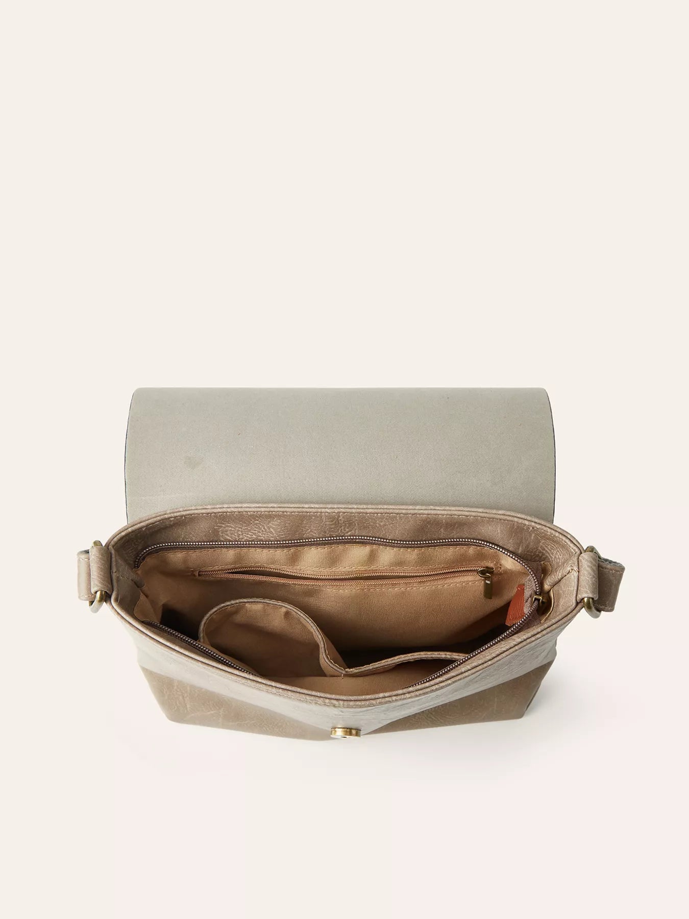 Open light gray crossbody bag with multiple interior compartments and zippered pockets for organization.