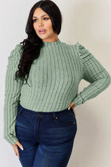 Woman wearing a light green Basic Bae ribbed mock neck long sleeve top with ruched puff shoulders, paired with dark blue jeans.
