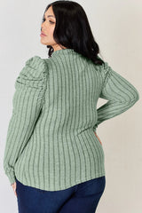 Woman wearing a light green Basic Bae ribbed mock neck long sleeve top with ruched puff shoulders, paired with dark blue jeans.