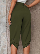 Model wearing matcha green roll-tab capri pants with side pockets and white sneakers for a casual outdoor look.
