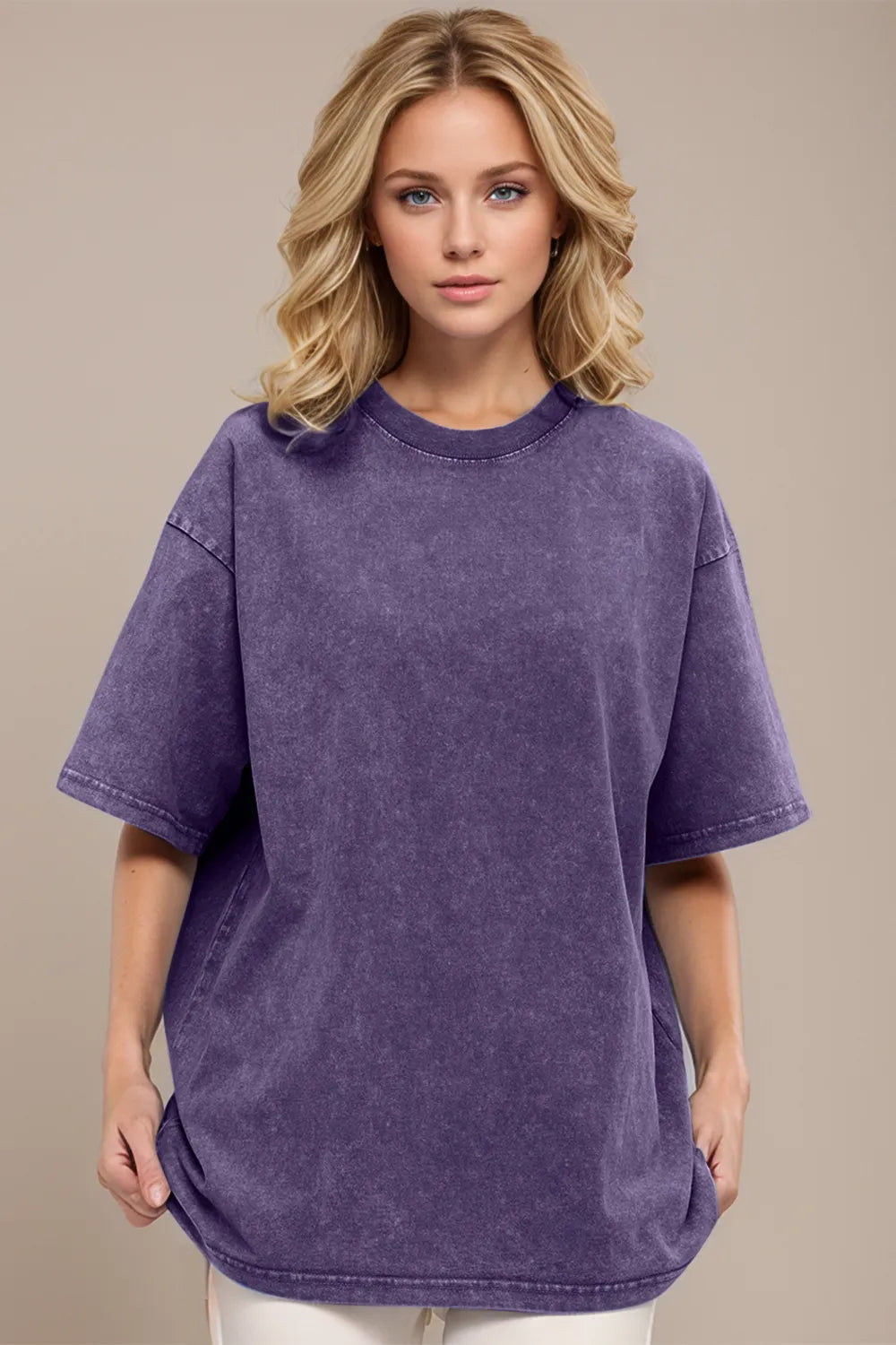 Woman wearing an oversized mauve Basic Bae round-neck half-sleeve T-shirt styled with dark denim jeans and a long pendant necklace for a relaxed, casual look.