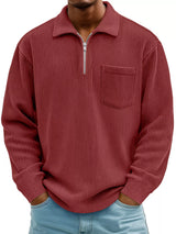 Man wearing a dark brown ribbed corduroy half zip long sleeve casual top with collar and chest pocket.