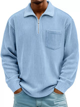 Man wearing a light blue ribbed corduroy half zip long sleeve casual top with collar and chest pocket.