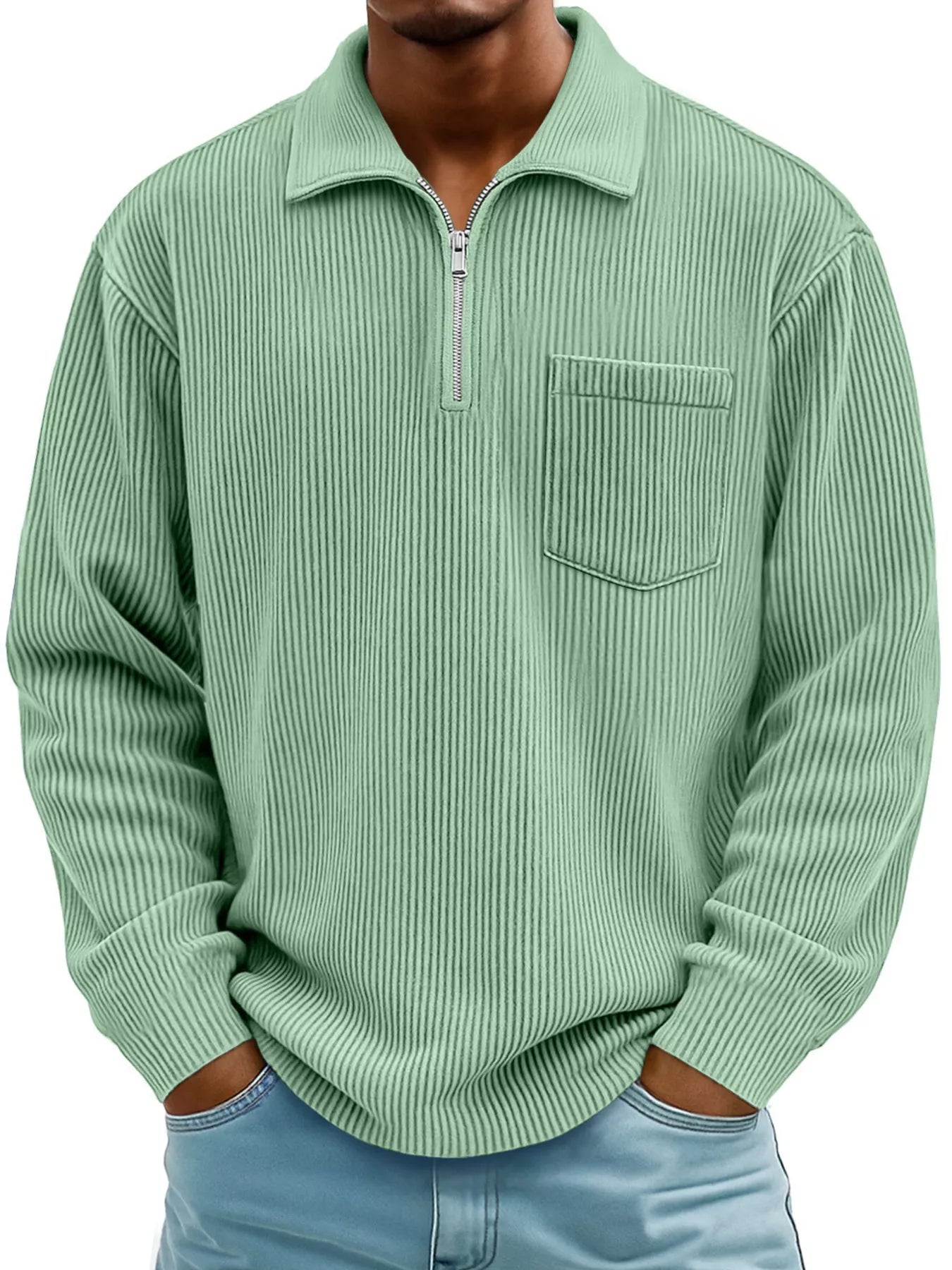 Man wearing a light green ribbed corduroy half zip long sleeve casual top with collar and chest pocket.