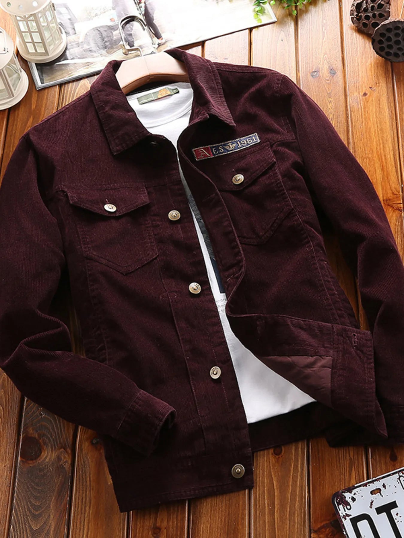 Men's paohong button-up long sleeve jacket with collared neckline, chest flap pockets, and textured fabric, displayed over a white graphic T-shirt.