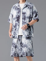 Men's plus size tie-dye two-piece outfit featuring a short sleeve button-up shirt and matching drawstring shorts in a dark navy and sage print.
