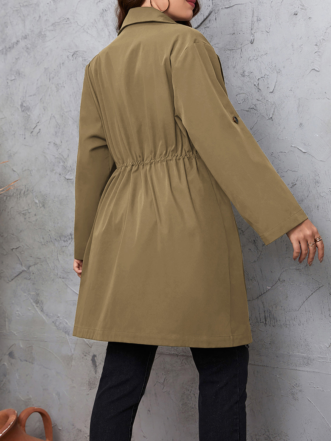 Woman wearing the Honey Plus Size Lapel Collar Drawstring Roll-Tab Sleeve Trench Coat in mocha with black denim and a black top, lightweight plus size fall trench coat from Chic Mystik Boutique.