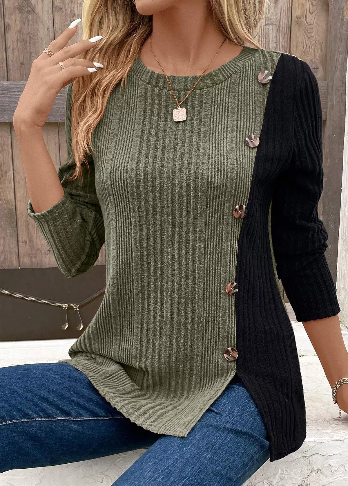 Women’s moss green and black color block ribbed knit long sleeve top with decorative side buttons and slit detail, available in sizes Small–2XL.