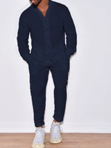 Men’s navy button up long sleeve top and matching pants two-piece set styled with white sneakers, available in sizes Small–2XL.