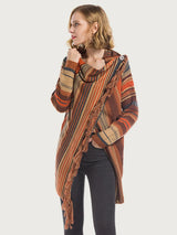Woman wearing the Angel Wings tassel striped open-front cardigan in ochre, featuring earthy multicolor stripes, a draped asymmetrical front, and long fringe trim.