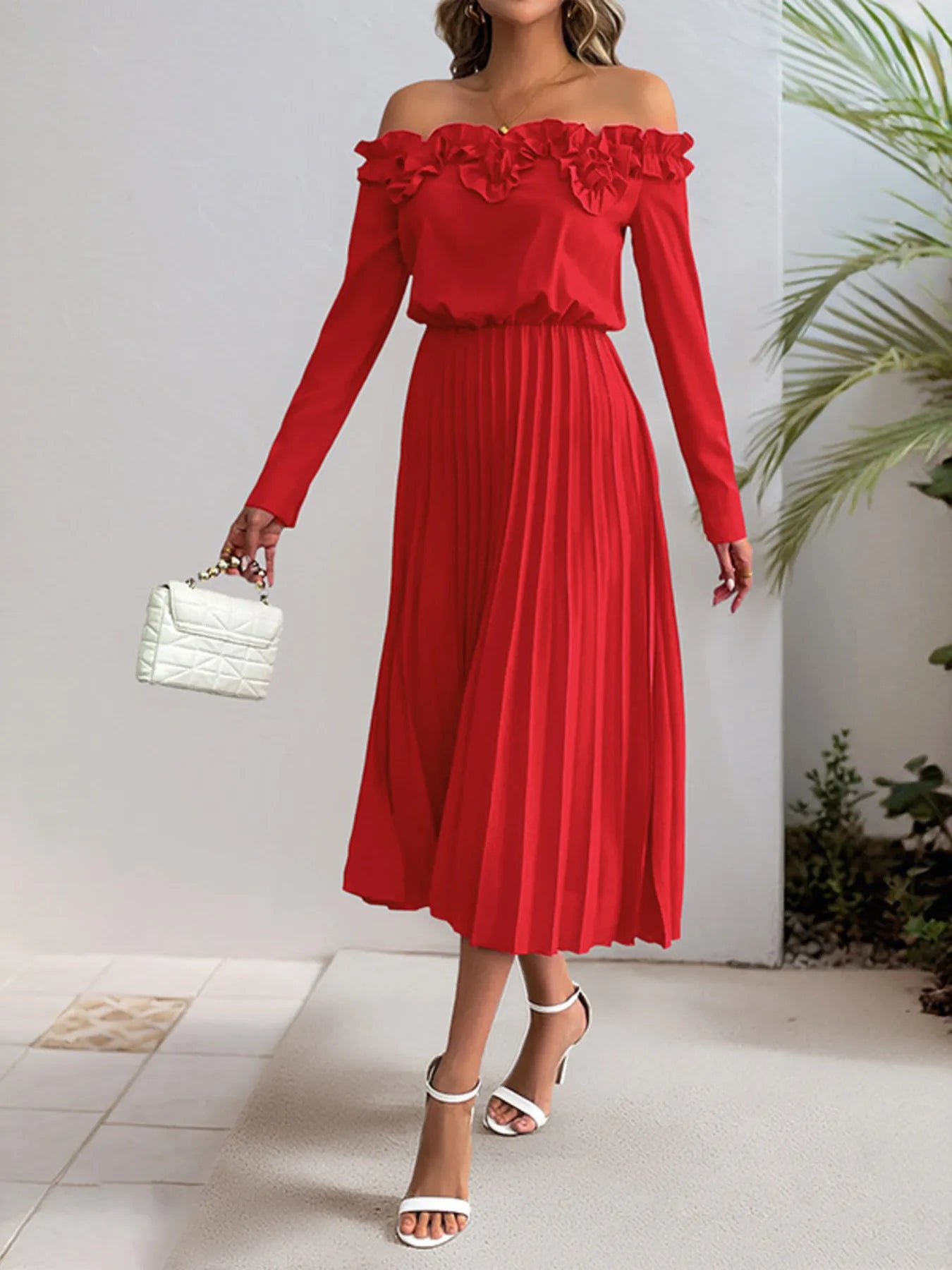 Red off-shoulder dress worn by a person with a white background