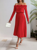 Red off-shoulder dress worn by a person with a white background