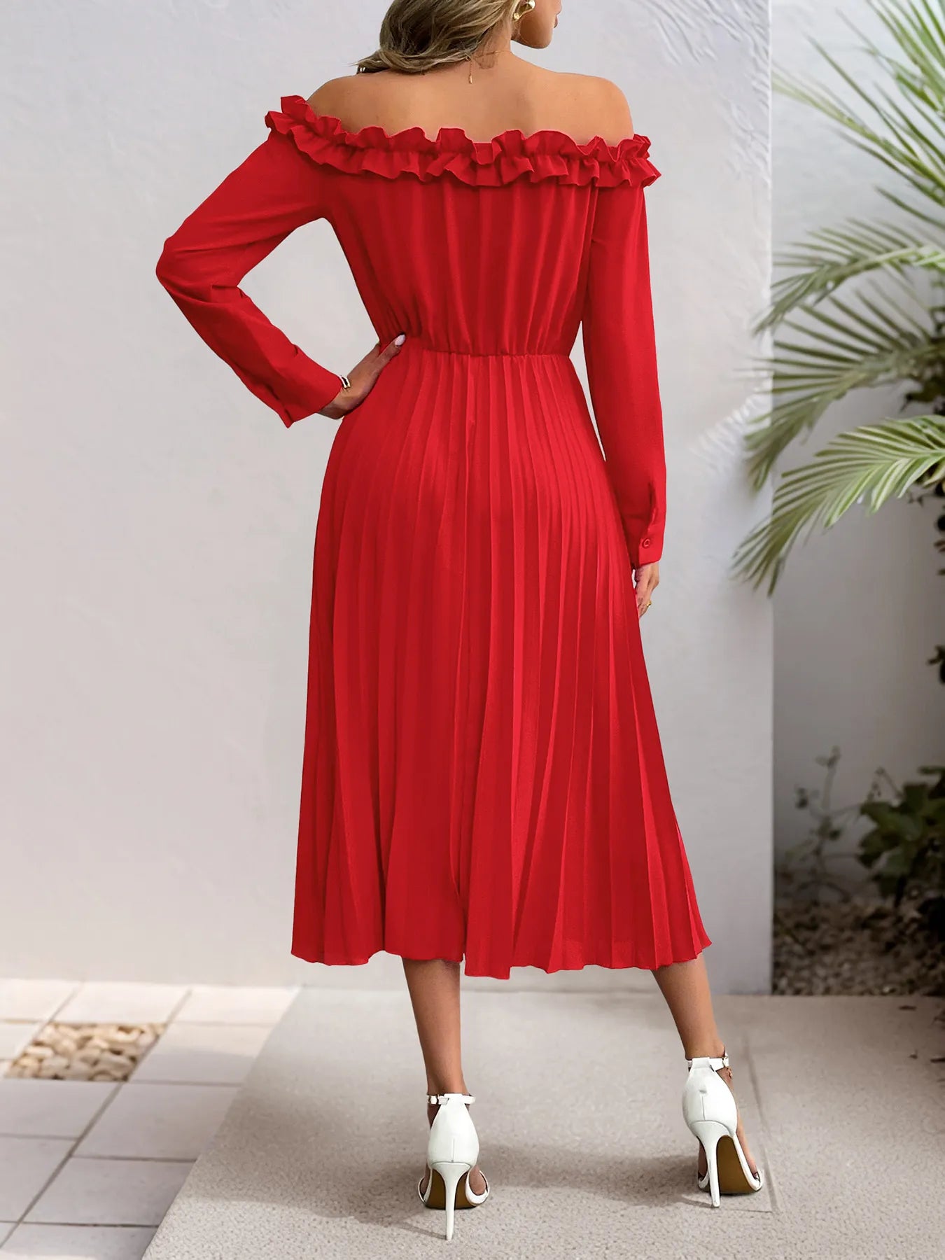 Red off-shoulder dress worn by a person on a neutral background showing back of the dress