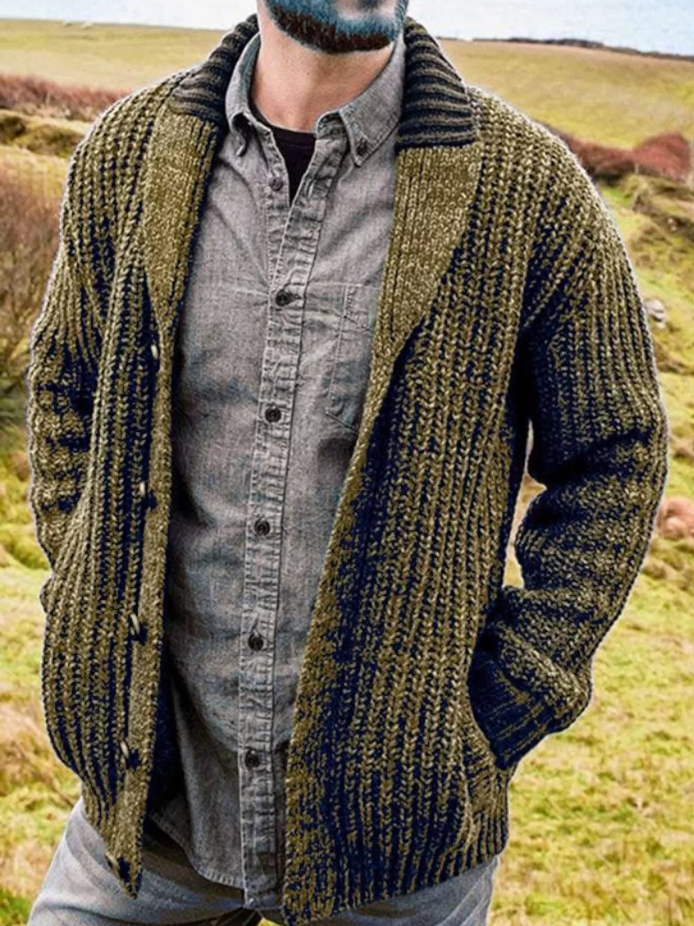 Men's olive chunky knit shawl collar cardigan with button-front closure, ribbed texture, and front pockets, layered over a gray button-down shirt.