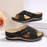 Black sandals with criss-cross straps on a light background