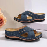 Pair of blue sandals with a beige flower on a light background