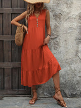 Woman wearing the Ivy Lane decorative button sleeveless dress with a notched neckline and a flattering silhouette.