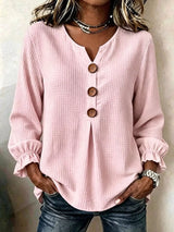 Women’s pink waffle knit flounce sleeve top with button front detail and ruffled cuffs.