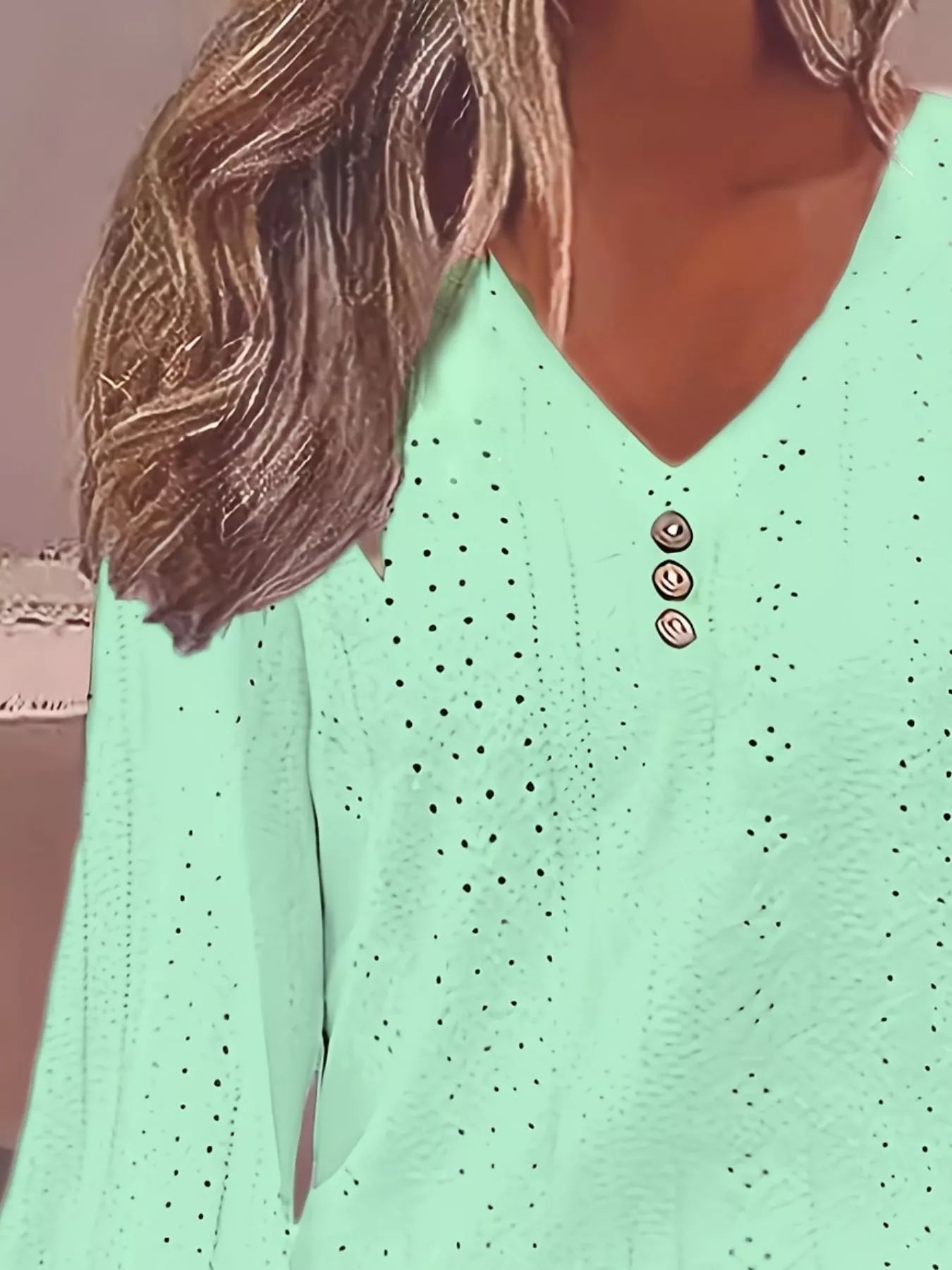 Light green blouse with button details worn by a person
