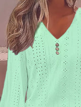 Light green blouse with button details worn by a person