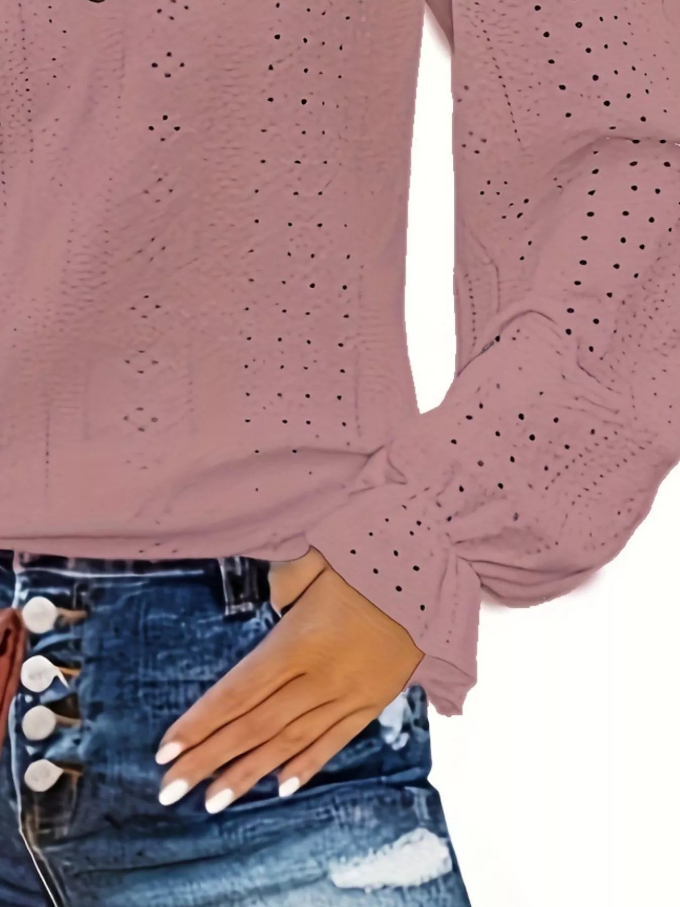 Rouge color long-sleeve top with eyelet details worn by a person, with a white background.