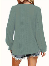 Green eyelet blouse with cut-out details worn by a person on a white background showing back of the blouse