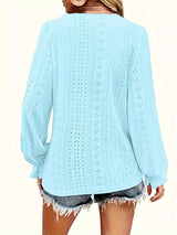 Light blue crochet top worn by a person on a white background show back of blouse