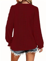 Red blouse worn by a person on a white background showing back of blouse