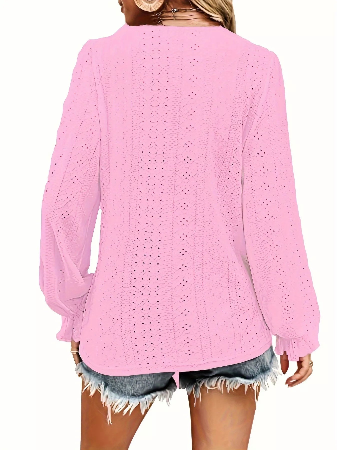 Pink crochet blouse worn by a person on a white background showing back of blouse