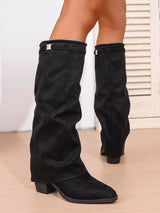Woman wearing black point toe block heel boots featuring a classic Western-inspired silhouette with a comfortable low heel, perfect for pairing with fall dresses, denim, and cozy sweaters.