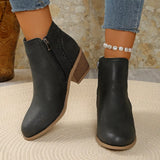 Women’s point toe block heel ankle boots with perforated side detail in black.