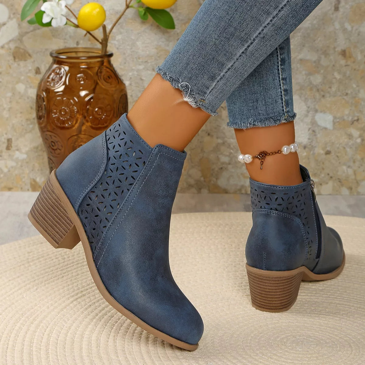 Women’s point toe block heel ankle boots with perforated side detail in blue.