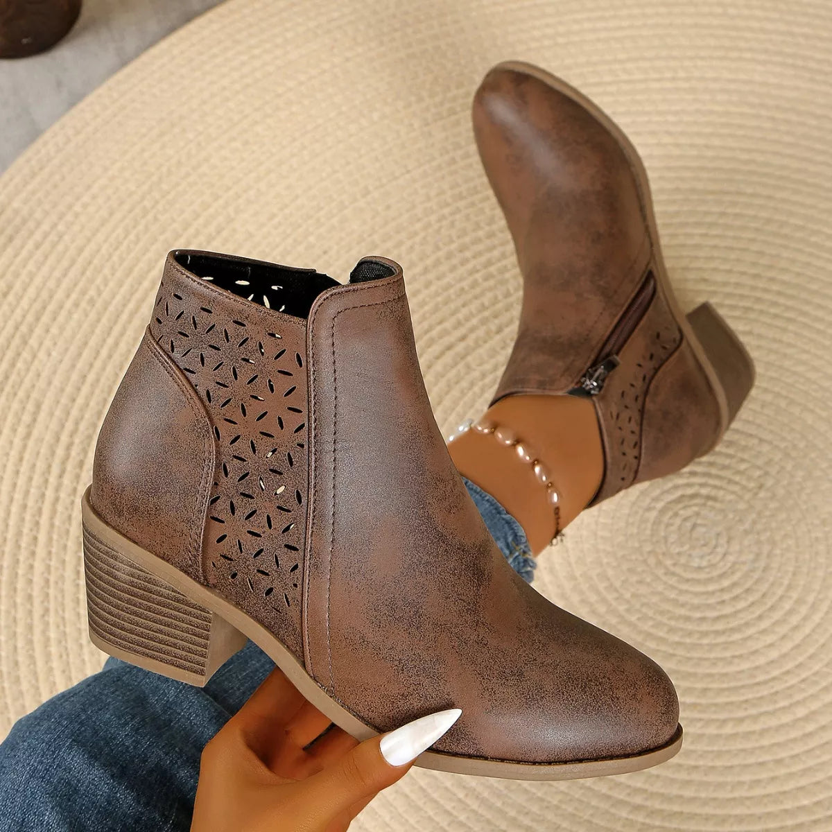 Women’s point toe block heel ankle boots with perforated side detail in brown.