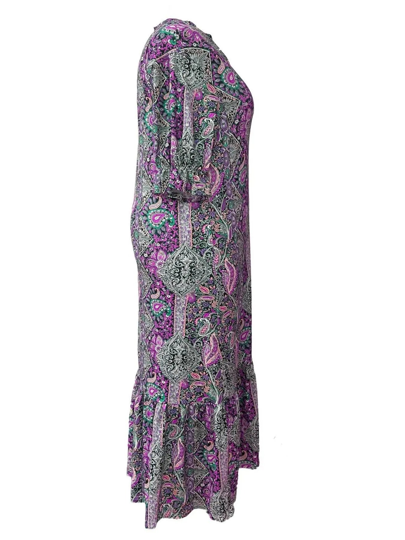 Woman wearing a purple bohemian paisley print midi dress with three-quarter sleeves and ruffled hem.