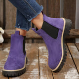 Purple suede round toe Chelsea ankle boots with black elastic side panels, mid-block heels and lug soles.