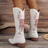 Women’s white Western cowboy boots with red embroidered detailing and mid-height block heels.