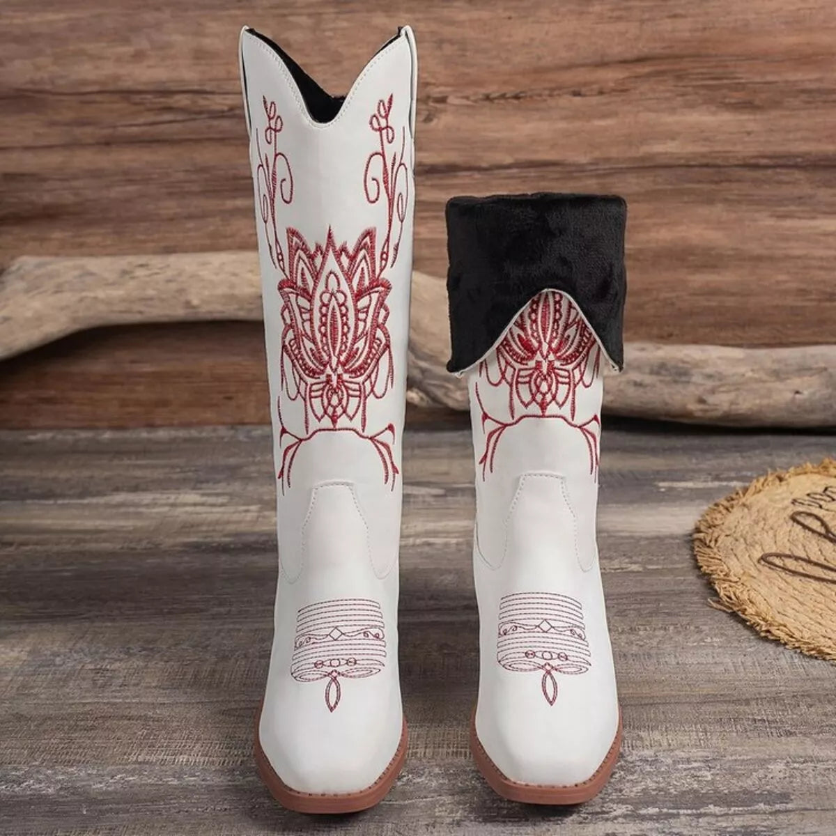 Women’s white Western cowboy boots with red embroidered detailing and mid-height block heels.