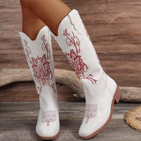 Women’s white Western cowboy boots with red embroidered detailing and mid-height block heels.