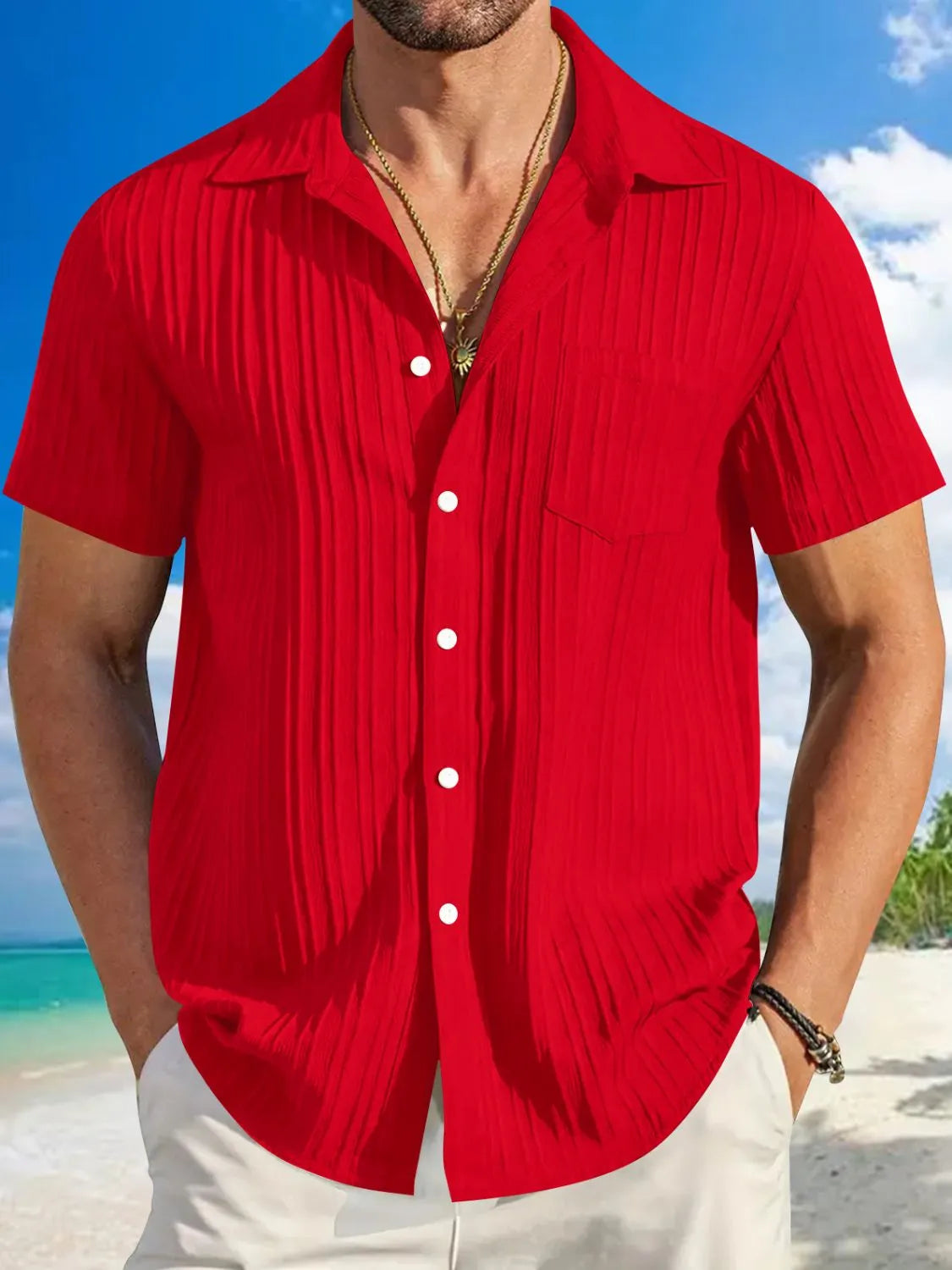 Man wearing red textured short sleeve button-up shirt with white pants for a polished casual summer look.