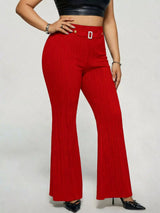 Model wearing red plus-size high-waisted flare pants styled with pointed-toe heels for an elegant and sophisticated look.