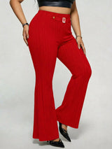 Model wearing red plus-size high-waisted flare pants styled with pointed-toe heels for an elegant and sophisticated look.