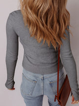 Women's ribbed button-up cardigan with subtle shimmer, long sleeves, and fitted silhouette, perfect for layering with jeans and fall outfits, available in sizes Small–XL.