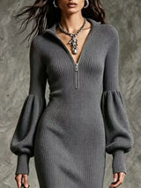 Woman wearing a gray ribbed knit quarter-zip sweater dress with long lantern sleeves, front slit and black embroidered western boots.