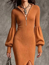 Woman wearing an ochre ribbed knit quarter-zip sweater dress with long lantern sleeves, front slit and black embroidered western boots.