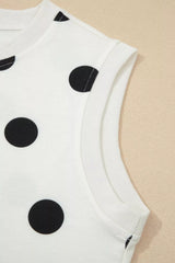 White sleeveless top with black polka dots on a beige background