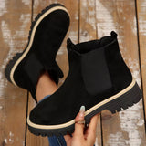 Black suede round toe Chelsea ankle boots with black elastic side panels, mid-block heels and lug soles.