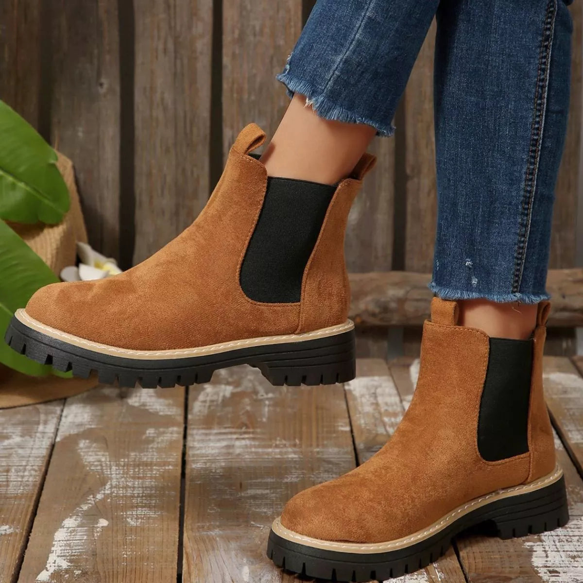 Brown suede round toe Chelsea ankle boots with black elastic side panels, mid-block heels and lug soles.