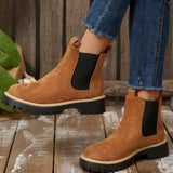 Brown suede round toe Chelsea ankle boots with black elastic side panels, mid-block heels and lug soles.